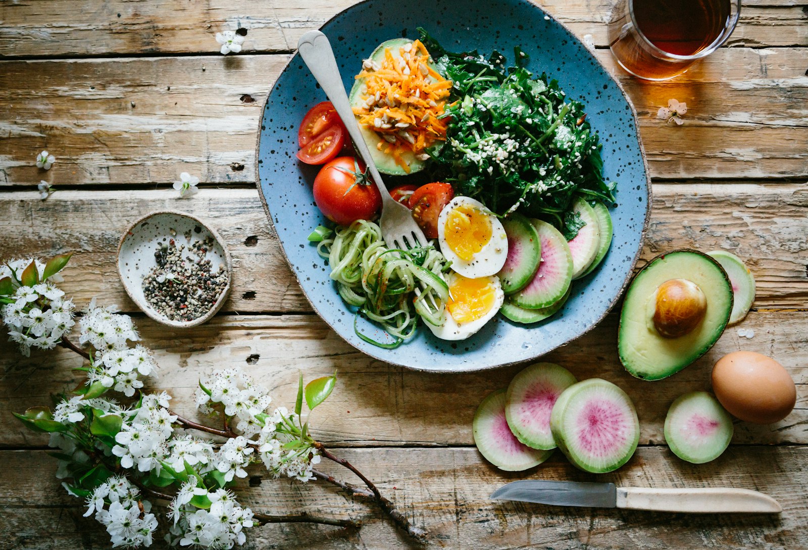 Healthy bowl of greens, eggs and avocado