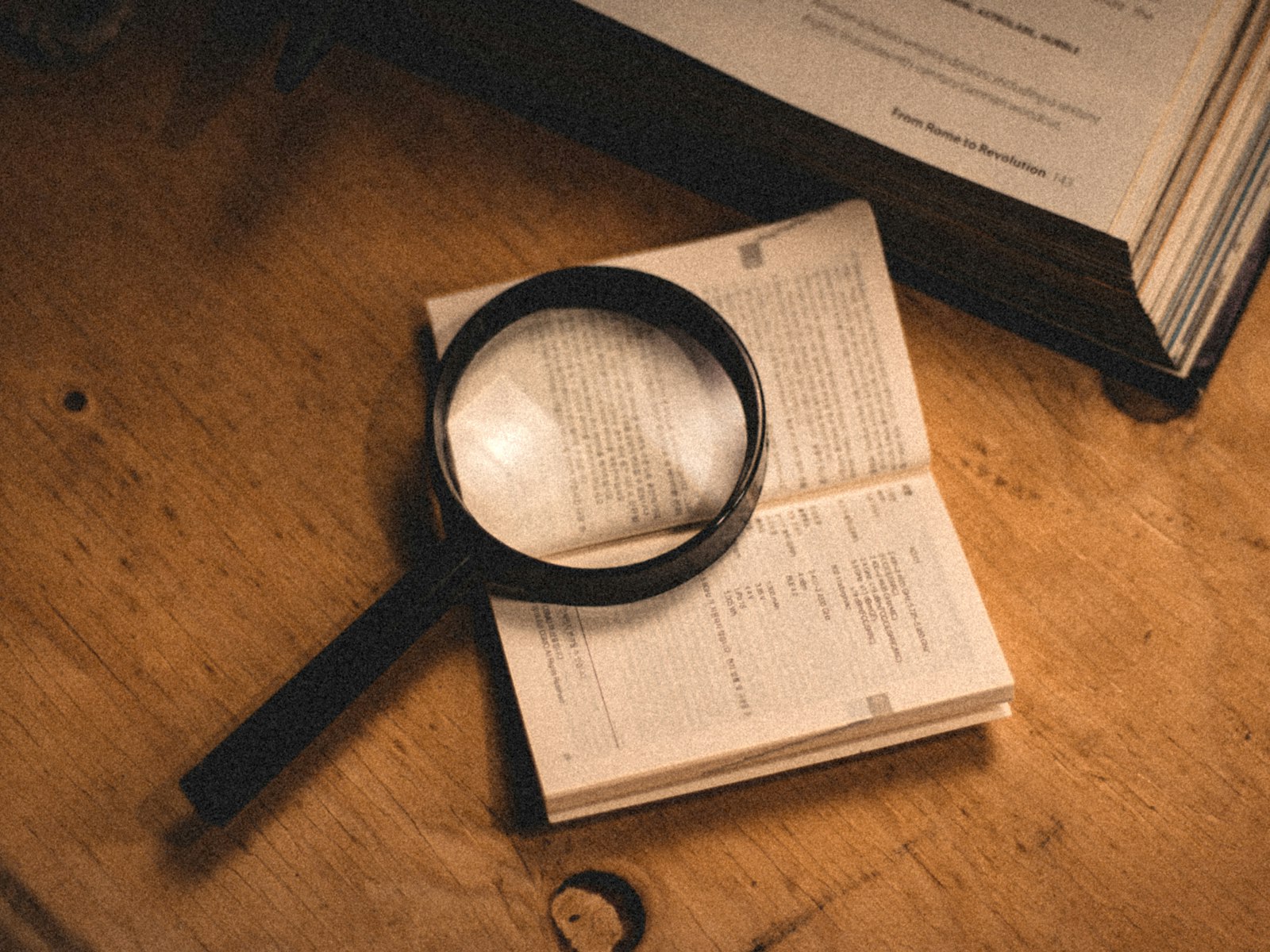 Magnifying glass resting on an open book