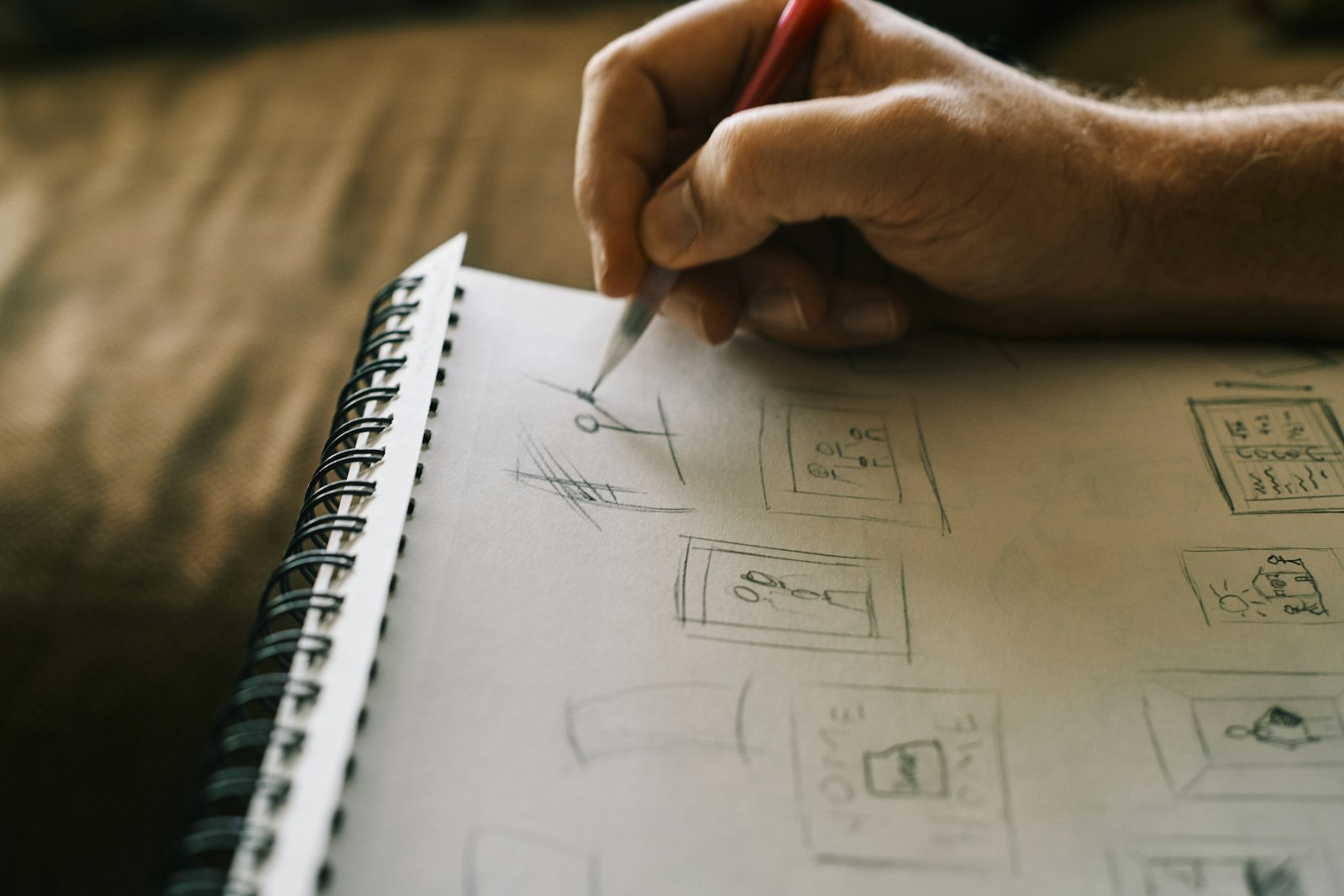 Designer sketching logo ideas in a notebook